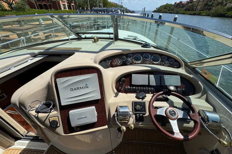 Slide: The Image of 2002 Sea Ray 380 Sundancer docked by colorful waterfront buildings. - 2