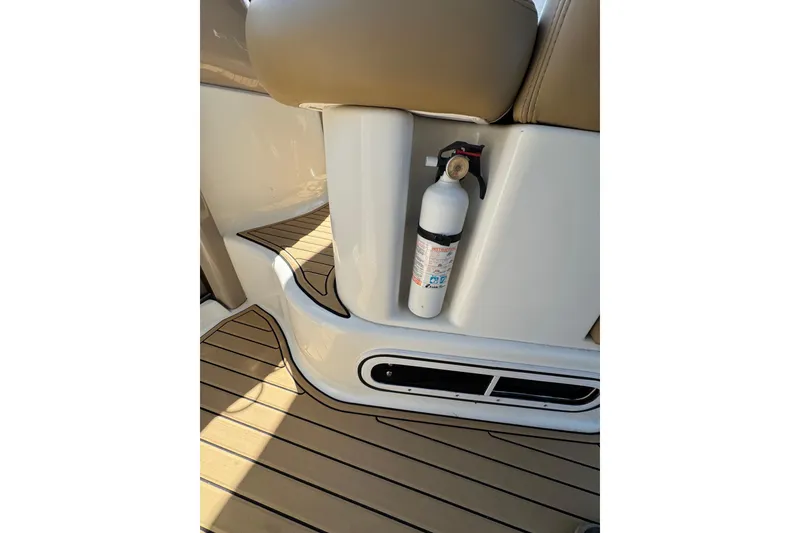 Slide: The Image of 2002 Sea Ray 380 Sundancer interior with fire extinguisher and teak flooring. - 20