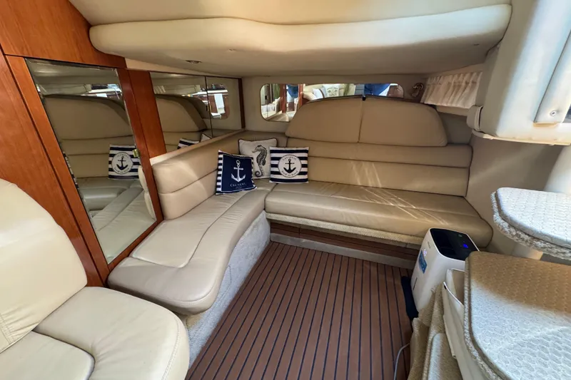 Slide: The Image of Luxurious interior of a 2002 Sea Ray 380 Sundancer yacht with beige seating and nautical decor. - 22