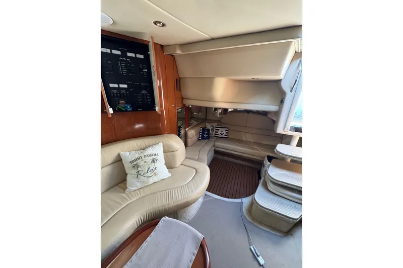 Slide: The Image of Interior of 2002 Sea Ray 380 Sundancer yacht with beige seating and nautical decor. - 23