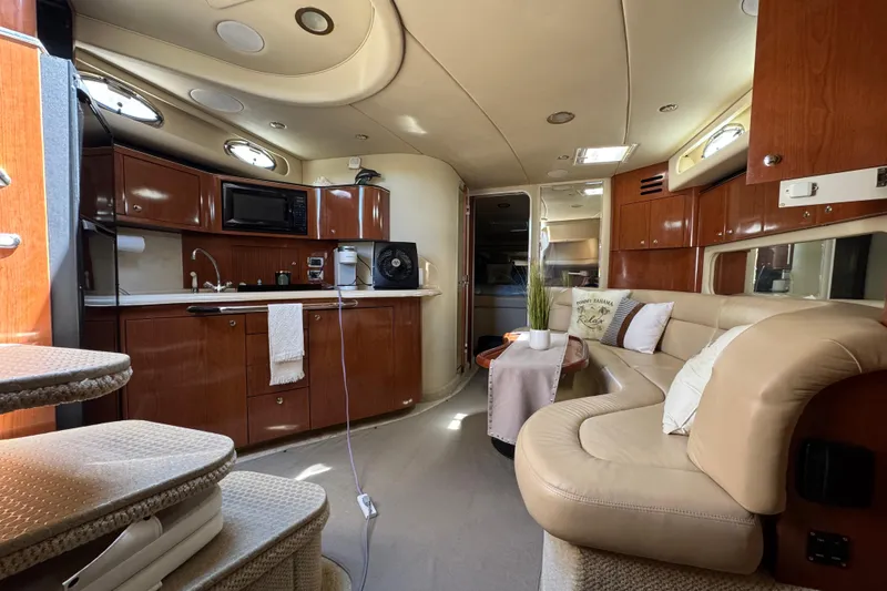 Slide: The Image of Luxurious interior of a 2002 Sea Ray 380 Sundancer yacht with elegant seating and kitchenette. - 25