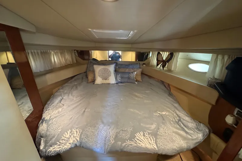 Slide: The Image of Luxurious cabin interior of 2002 Sea Ray 380 Sundancer with elegant bedding and decor. - 26