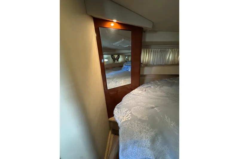 Slide: The Image of Interior cabin of 2002 Sea Ray 380 Sundancer with mirror and bed. - 28