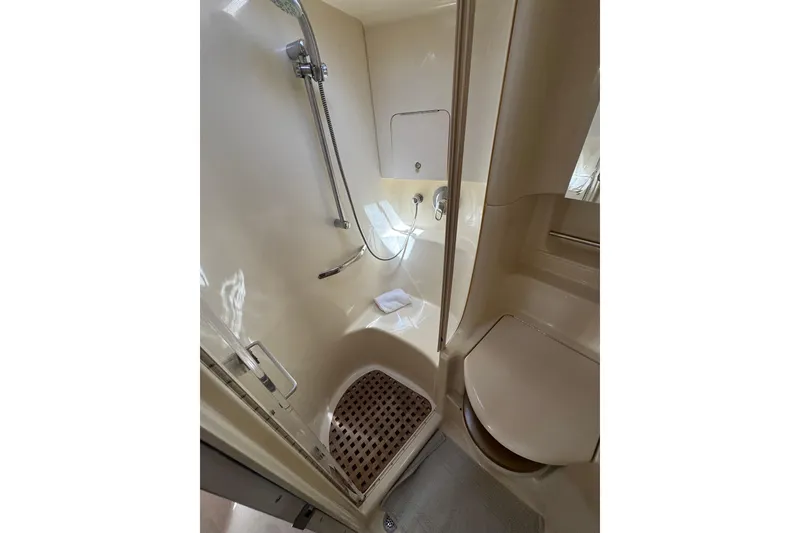 Slide: The Image of Bathroom interior of 2002 Sea Ray 380 Sundancer yacht, featuring shower and toilet. - 31