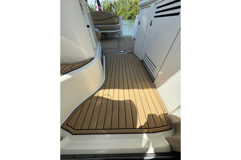 Slide: The Image of 2002 Sea Ray 380 Sundancer boat interior with teak flooring and seating area. - 35