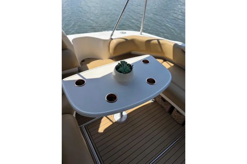 Slide: The Image of Cockpit seating area on a 2002 Sea Ray 380 Sundancer with a table and potted plant. - 37