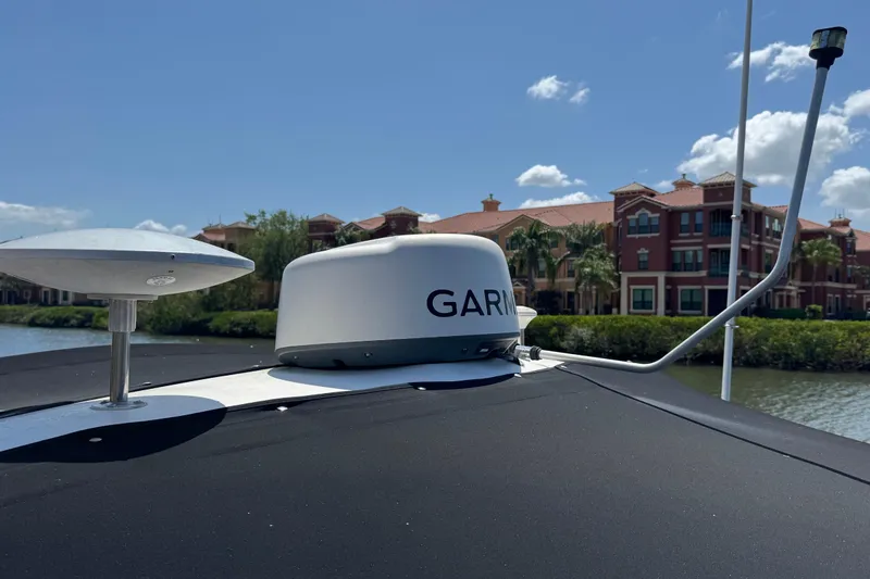 Slide: The Image of Radar equipment on a 2002 Sea Ray 380 Sundancer boat, with waterfront buildings in the background. - 42