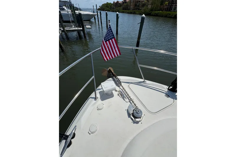 Slide: The Image of Bow of 2002 Sea Ray 380 Sundancer with American flag and anchor chain. - 44
