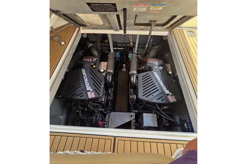 Slide: The Image of Engine compartment of a 2002 Sea Ray 380 Sundancer with twin Mercury engines. - 48