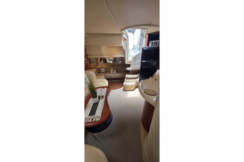 Slide: The Image of Interior of 2002 Sea Ray 380 Sundancer yacht, featuring elegant seating and modern amenities. - 50