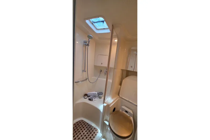 Slide: The Image of Bathroom interior of 2002 Sea Ray 380 Sundancer yacht, featuring shower and toilet. - 51