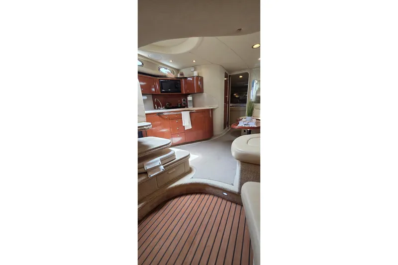 Slide: The Image of Interior of 2002 Sea Ray 380 Sundancer yacht with kitchen and seating area. - 52