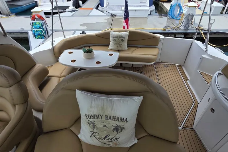 Slide: The Image of Luxurious 2002 Sea Ray 380 Sundancer yacht interior with plush seating and elegant table setup. - 54
