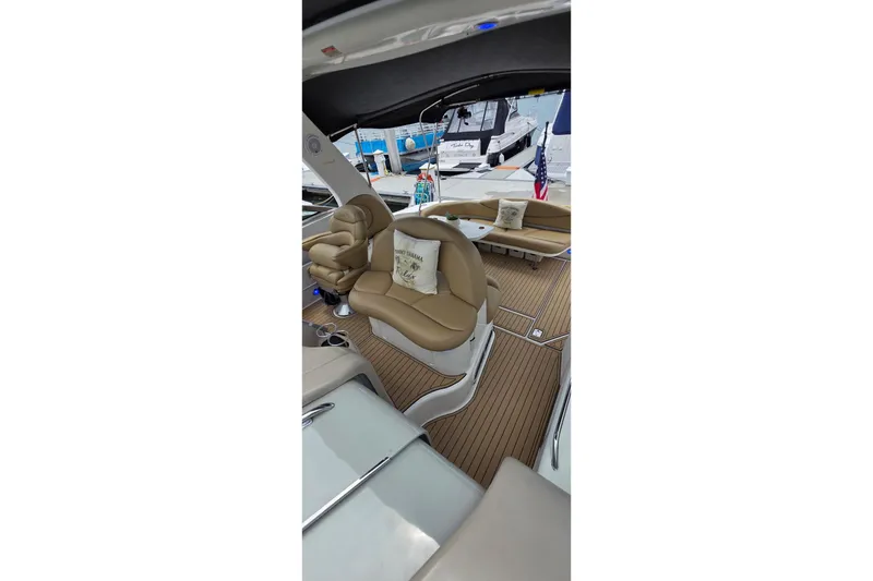 Slide: The Image of Interior of 2002 Sea Ray 380 Sundancer yacht with tan seating and wooden flooring. - 67