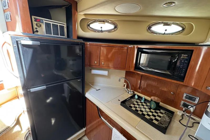 Slide: The Image of Luxurious seating on 2002 Sea Ray 380 Sundancer yacht, featuring tan leather upholstery. - 7