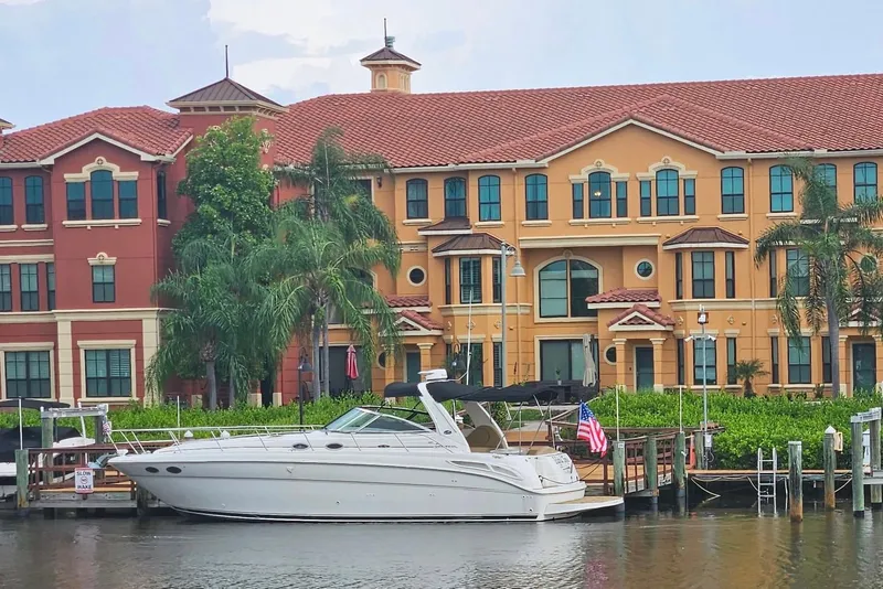 The Image of 2002 Sea Ray 380 Sundancer docked by colorful waterfront buildings. - 8