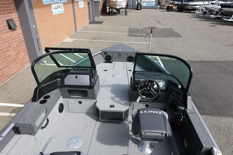 Slide: The Image of 2026 Lund 1875 Impact XS Sport boat interior with seating and steering console. - 17