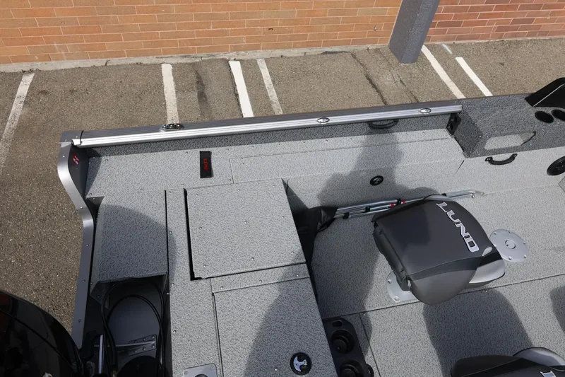Slide: The Image of 2026 Lund 1875 Impact XS Sport boat interior with seating and storage compartments. - 18