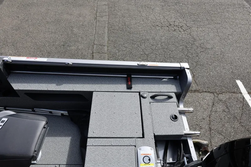 Slide: The Image of 2026 Lund 1875 Impact XS Sport boat interior with seating and storage compartments. - 20