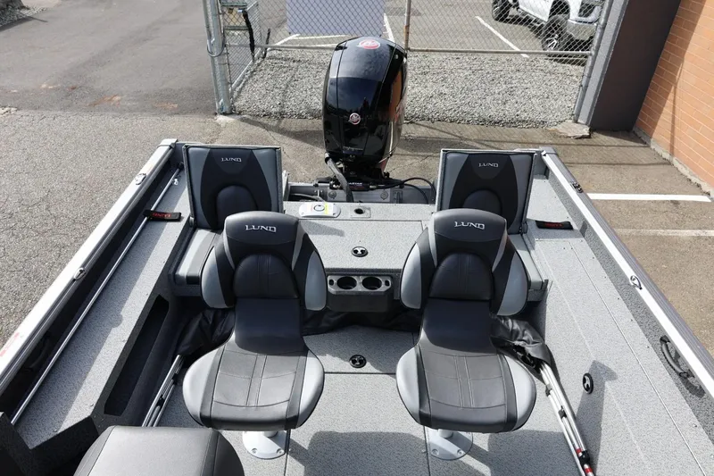 Slide: The Image of 2026 Lund 1875 Impact XS Sport boat interior with four seats and motor. - 22