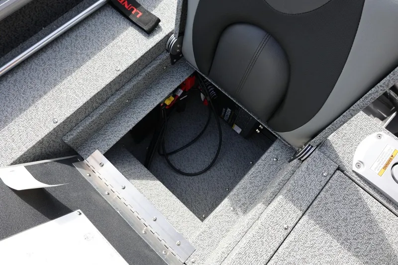 Slide: The Image of 2026 Lund 1875 Impact XS Sport boat interior with storage compartment and seat detail. - 24