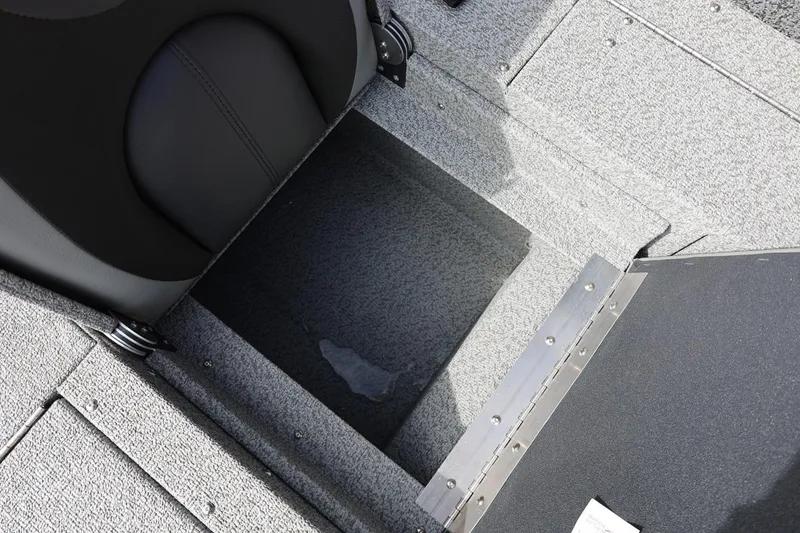 Slide: The Image of Interior view of 2026 Lund 1875 Impact XS Sport boat, featuring storage compartment and seating. - 26