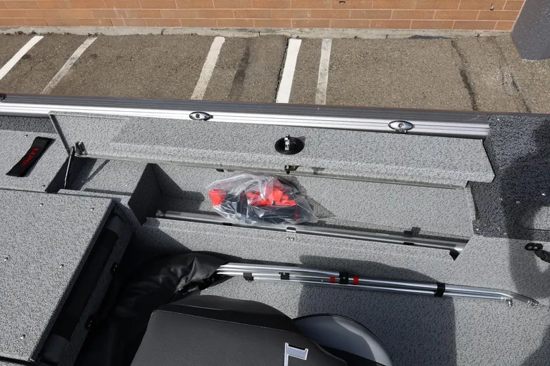 Slide: The Image of 2026 Lund 1875 Impact XS Sport boat interior with storage compartment and accessories. - 29