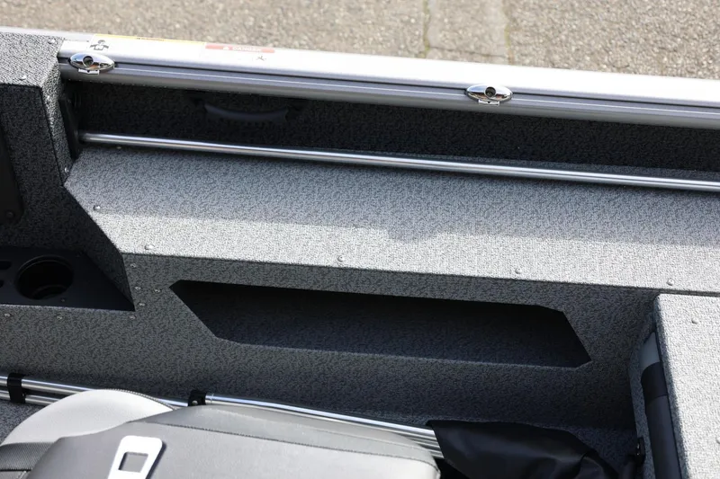 Slide: The Image of Interior view of 2026 Lund 1875 Impact XS Sport boat, featuring storage compartments. - 32