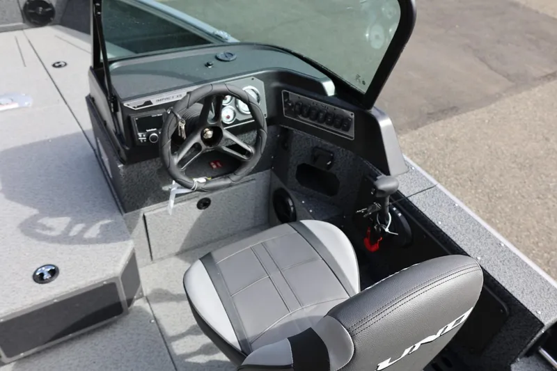Slide: The Image of 2026 Lund 1875 Impact XS Sport boat cockpit with steering wheel and seat. - 35