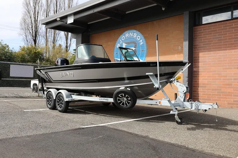 Slide: The Image of 2026 Lund 1875 Impact XS Sport boat on trailer, parked outdoors. - 4