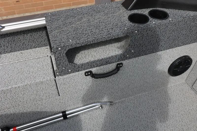 Slide: The Image of 2026 Lund 1875 Impact XS Sport boat interior with storage, cup holders, and speaker. - 40