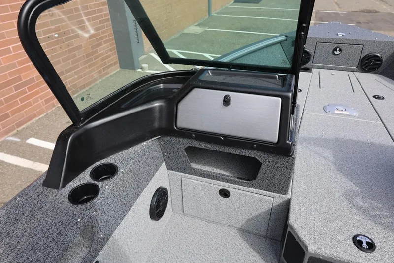 Slide: The Image of 2026 Lund 1875 Impact XS Sport boat interior with windshield and storage compartments. - 41