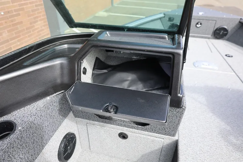 Slide: The Image of 2026 Lund 1875 Impact XS Sport boat interior storage compartment open. - 42