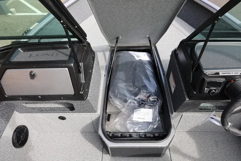 Slide: The Image of 2026 Lund 1875 Impact XS Sport boat interior with storage compartment open. - 44