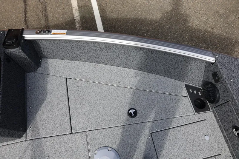 Slide: The Image of 2026 Lund 1875 Impact XS Sport boat interior, featuring textured flooring and storage compartments. - 47