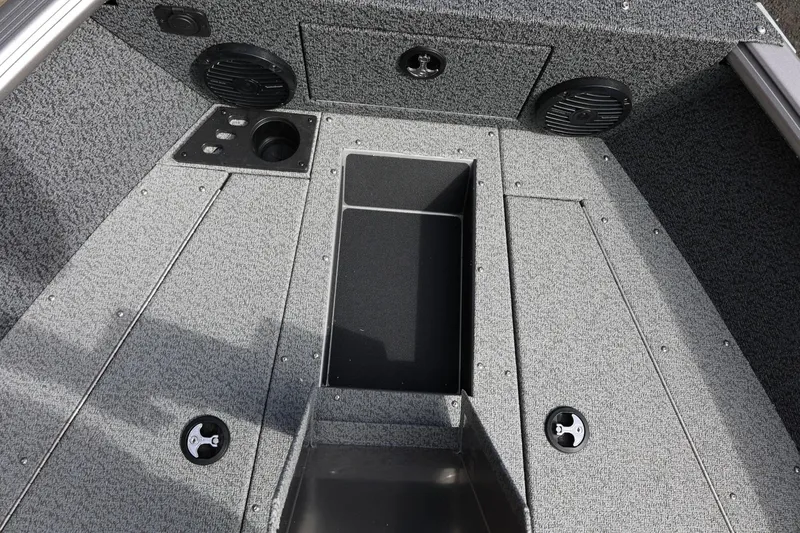 Slide: The Image of Interior view of 2026 Lund 1875 Impact XS Sport boat, featuring storage compartments and speakers. - 49