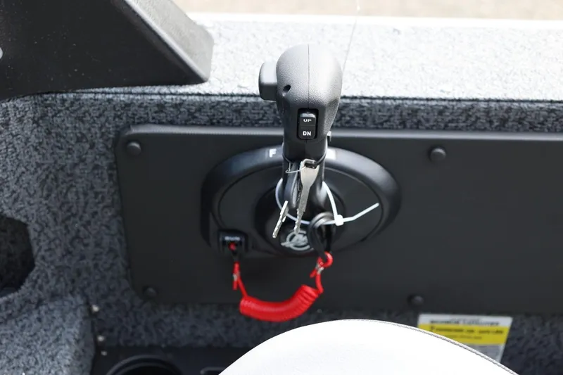 Slide: The Image of Control panel of 2026 Lund 1875 Impact XS Sport boat with throttle and key. - 52