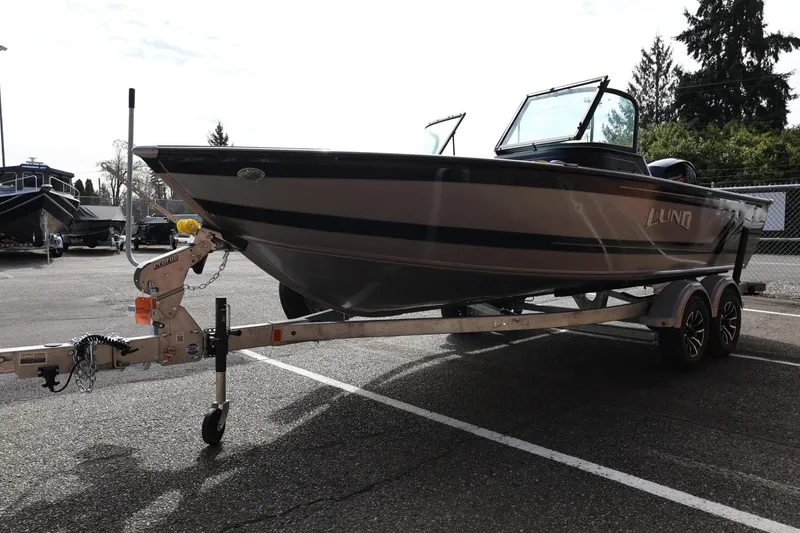 Slide: The Image of 2026 Lund 1875 Impact XS Sport boat on trailer in parking lot. - 8