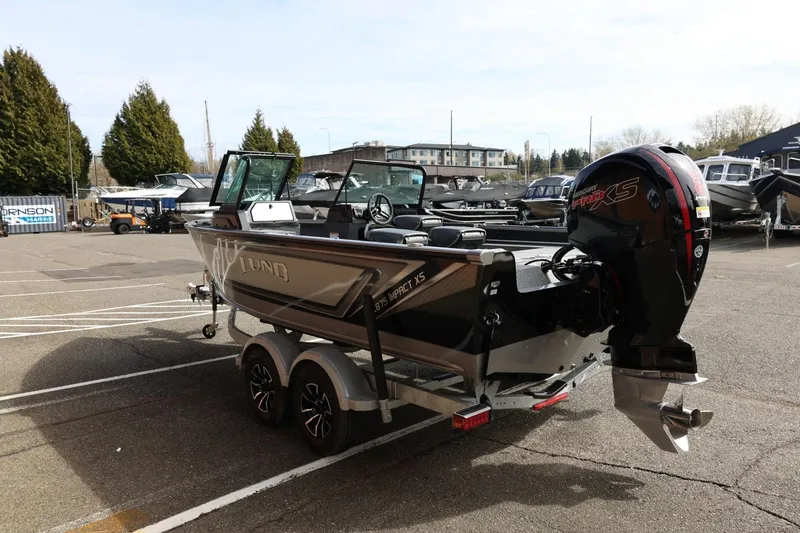 Slide: The Image of 2026 Lund 1875 Impact XS Sport boat on trailer in parking lot. - 9