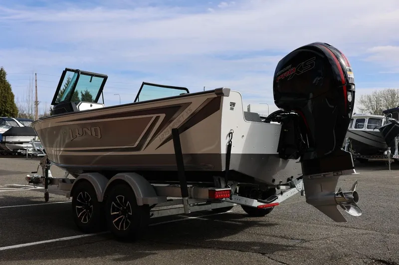 Slide: The Image of 2026 Lund 1875 Impact XS Sport boat on trailer, featuring Mercury Pro XS outboard motor. - 10