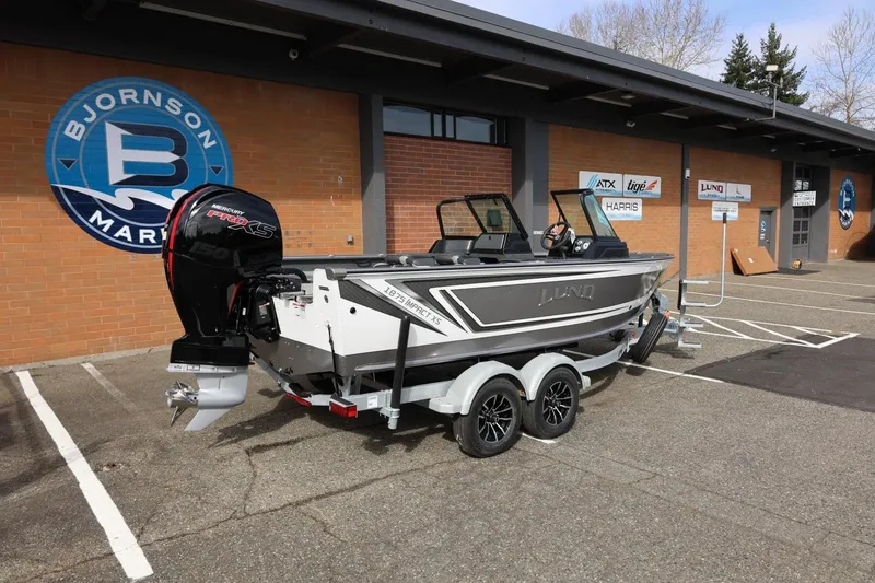 Slide: The Image of 2026 Lund 1875 Impact XS Sport boat on trailer outside Bjornson Marine. - 14