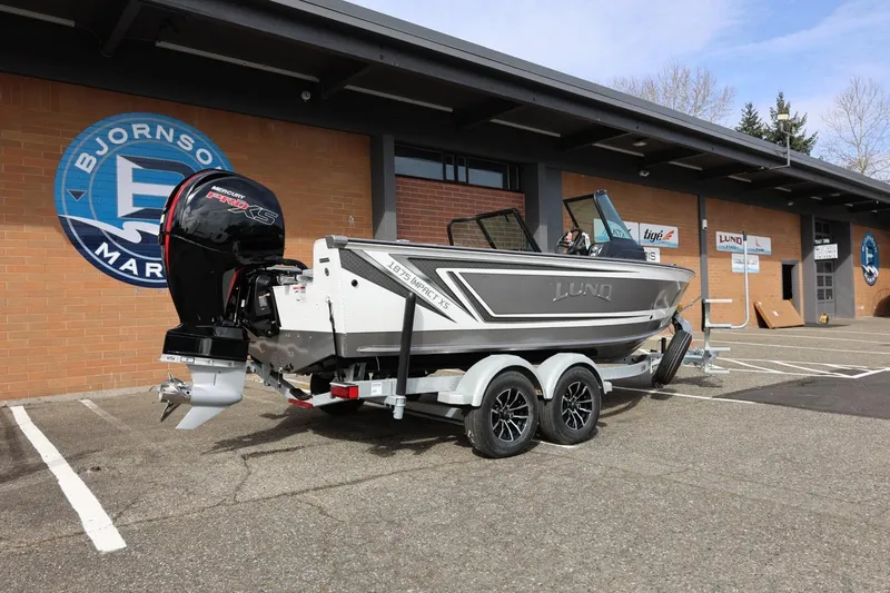Slide: The Image of 2026 Lund 1875 Impact XS Sport boat on trailer outside Bjornson Marine. - 15