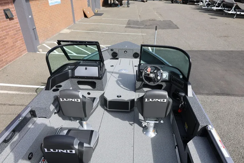 Slide: The Image of 2026 Lund 1875 Impact XS Sport boat interior with dual seats and steering console. - 16