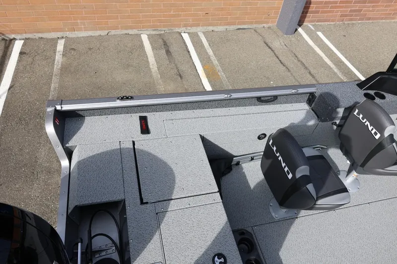 Slide: The Image of 2026 Lund 1875 Impact XS Sport boat interior with seating and storage compartments. - 17