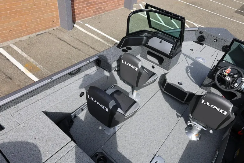 Slide: The Image of 2026 Lund 1875 Impact XS Sport boat interior with seating and steering console. - 18