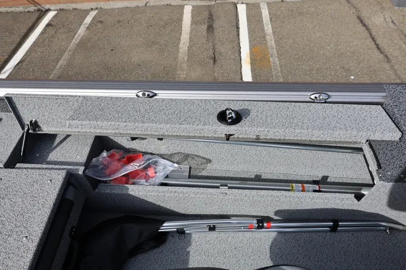 Slide: The Image of Interior view of 2026 Lund 1875 Impact XS Sport boat storage compartment. - 26