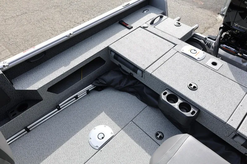 Slide: The Image of 2026 Lund 1875 Impact XS Sport boat interior with storage compartments and cup holders. - 27