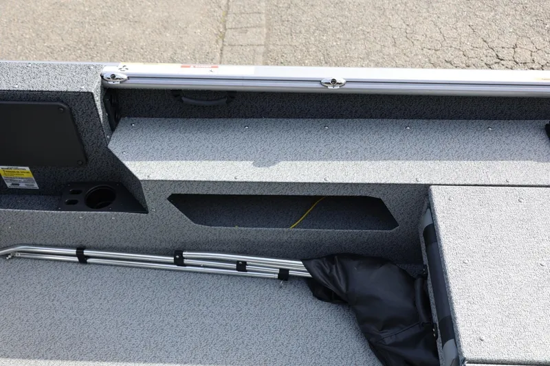 Slide: The Image of 2026 Lund 1875 Impact XS Sport boat interior with storage compartments and rod holders. - 29