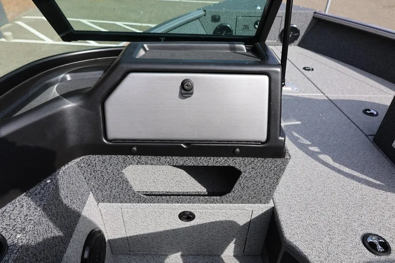 Slide: The Image of 2026 Lund 1875 Impact XS Sport boat interior with storage compartment and sleek design. - 38