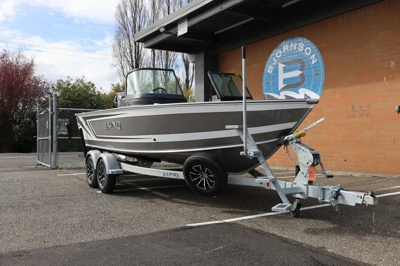 Slide: The Image of 2026 Lund 1875 Impact XS Sport boat on trailer, parked outdoors. - 4